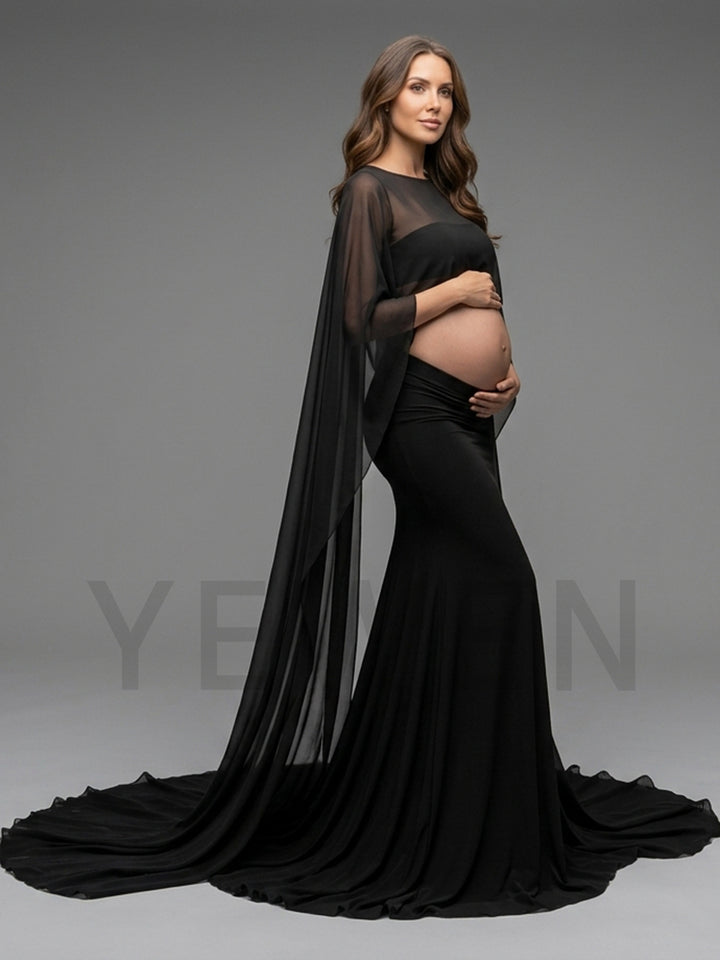 Side profile of a black sheer cape sleeve pregnancy photoshoot dress showing the flowing silhouette.