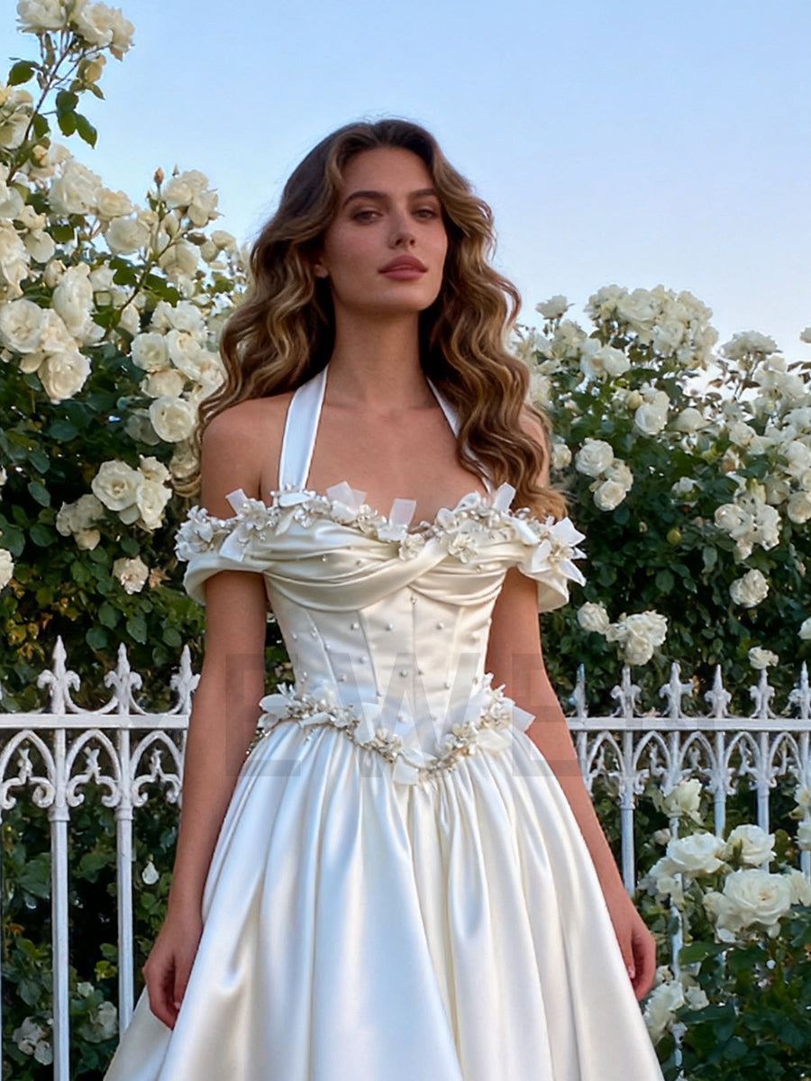 Bride wearing princess 3D flower wedding dress in studio bridal photoshoot with satin elegance
