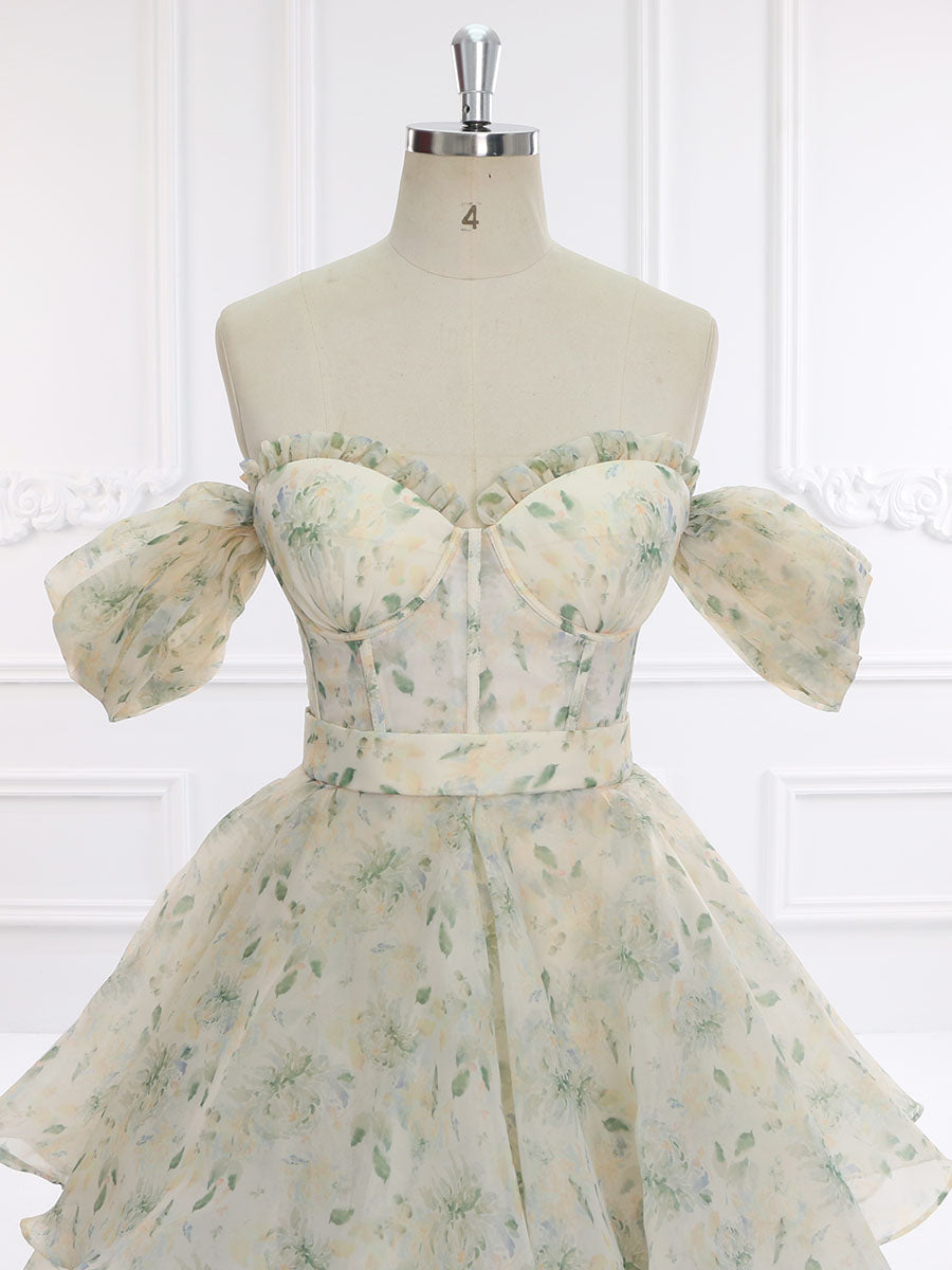 Close-up front detail of prom dress showing colorful floral print texture and elegant fabric craftsmanship