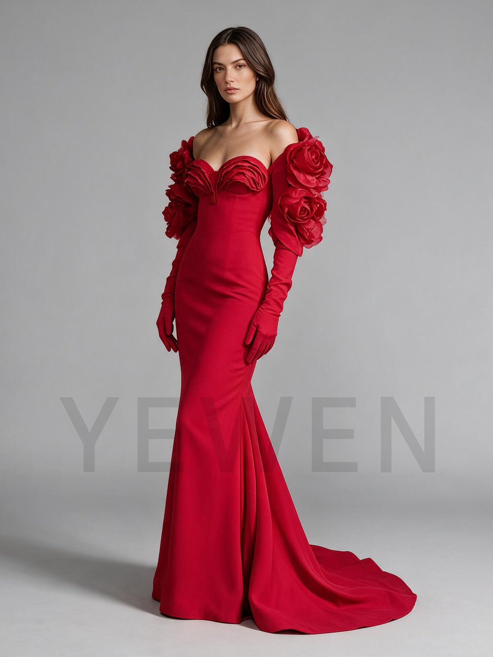 Side profile of a red mermaid evening gown with 3D rose sleeve details.