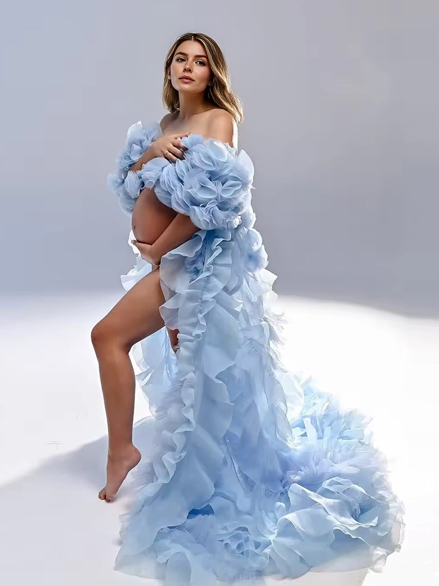 Woman wearing a light blue, ruffled dress against a gray background
