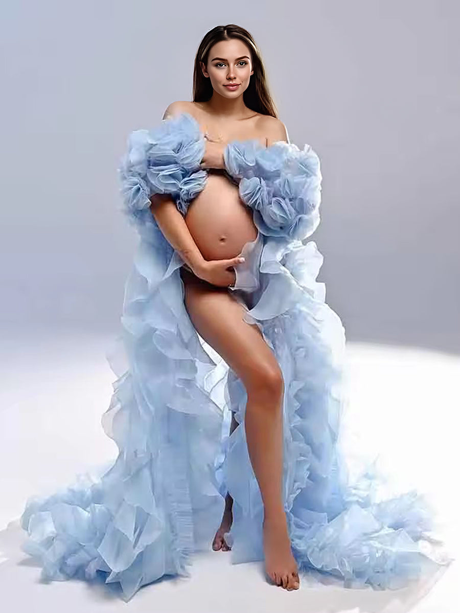Woman wearing chic organza ruffles photoshoot robe cape in elegant studio maternity photography setting