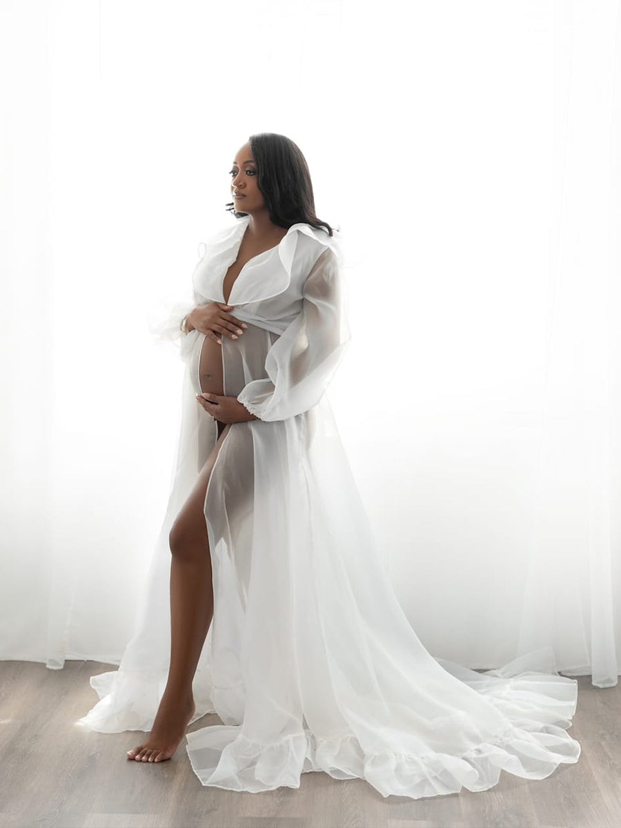 Pregnant woman wearing silk organza maternity dress in studio maternity and baby shower photoshoot