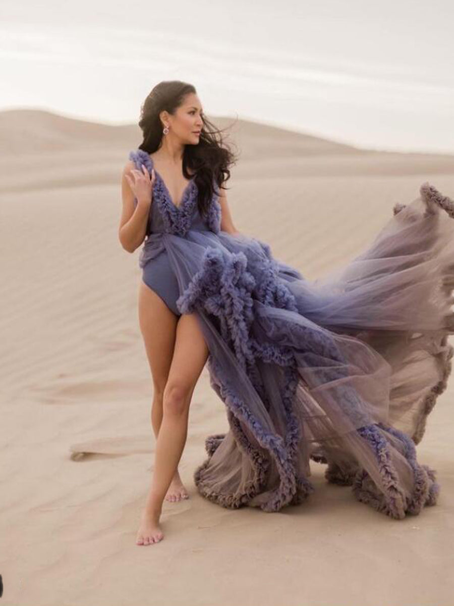 Flowing sleeveless maternity dress for photoshoot captured in motion showing elegant ruffle movement
