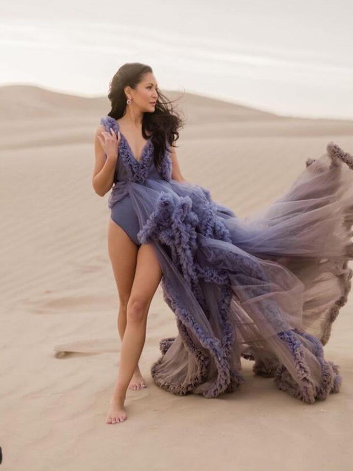 Flowing sleeveless maternity dress for photoshoot captured in motion showing elegant ruffle movement