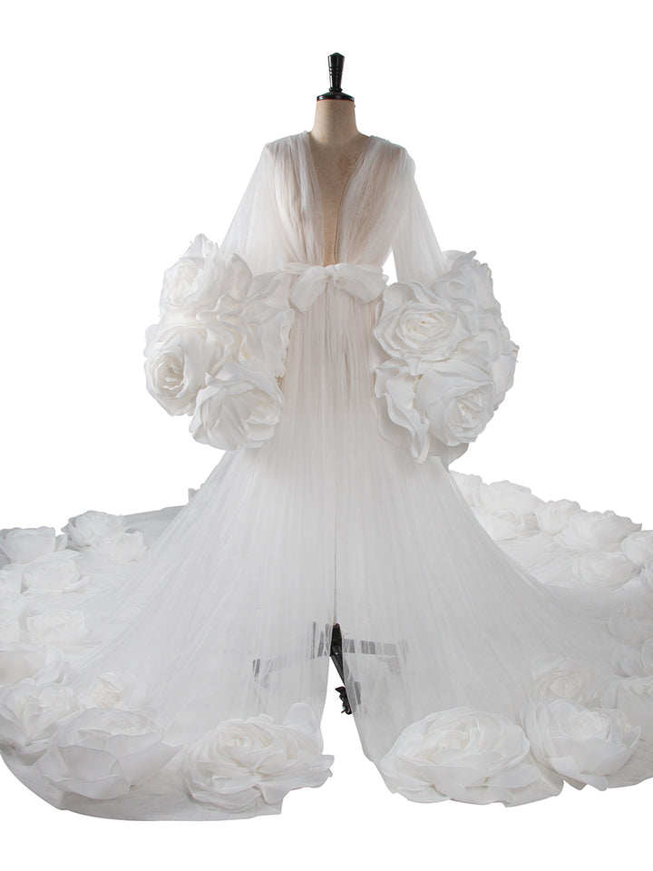 White wedding dress with floral details on a mannequin against a white background
