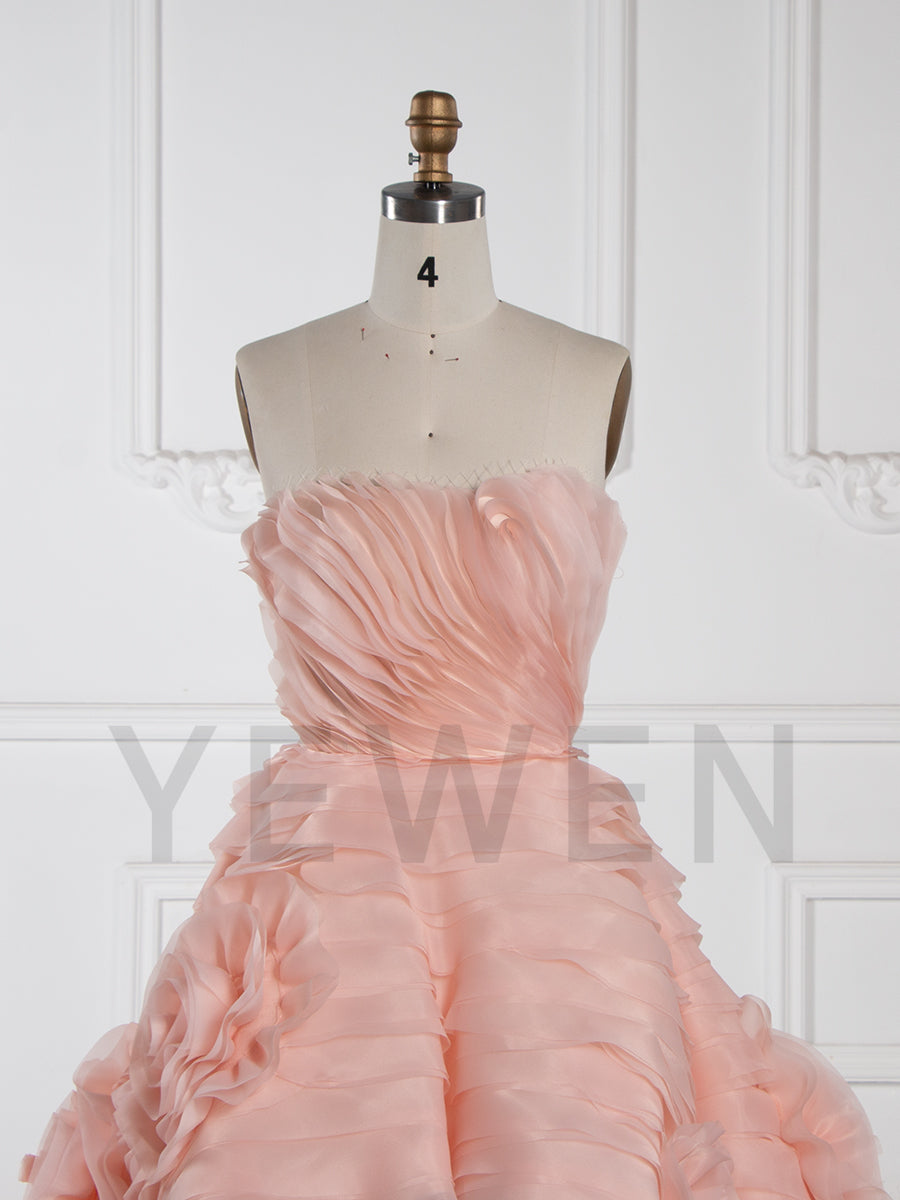 Front view of strapless tiered flower evening dress featuring layered floral design and elegant formal silhouette