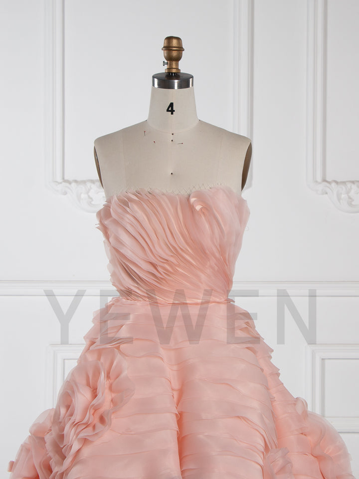 Front view of strapless tiered flower evening dress featuring layered floral design and elegant formal silhouette