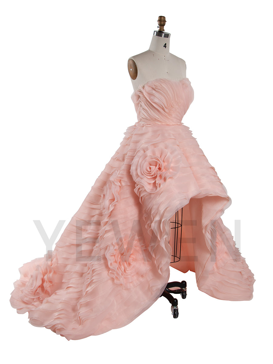 Side view of strapless tiered flower evening dress showing layered floral tiers and elegant flowing structure