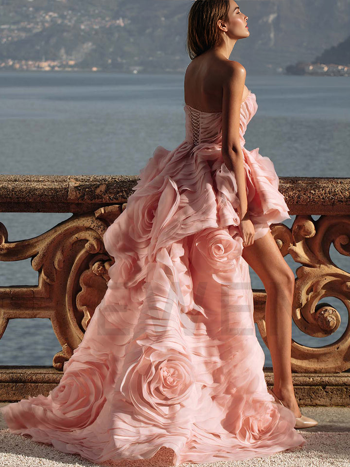 Side view of strapless tiered flower evening dress showing layered floral tiers and elegant flowing structure
