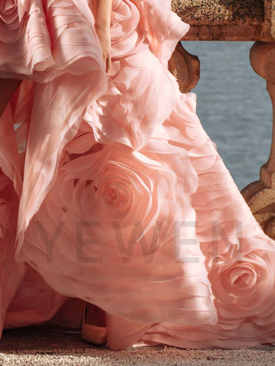 Close-up of tiered floral detailing on strapless evening dress showing luxury craftsmanship and layered texture