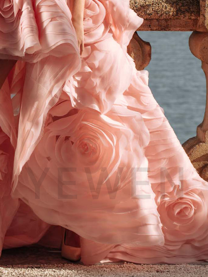 Close-up of tiered floral detailing on strapless evening dress showing luxury craftsmanship and layered texture