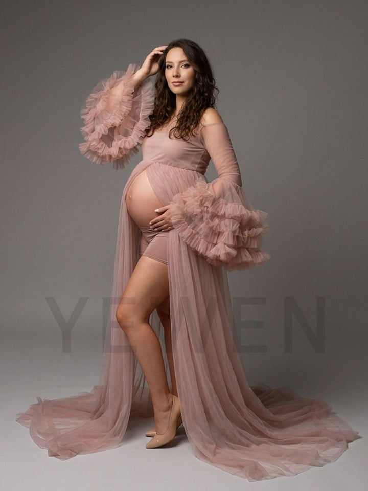Side profile of a dusty pink tulle maternity photoshoot gown showing the ruffle sleeves.