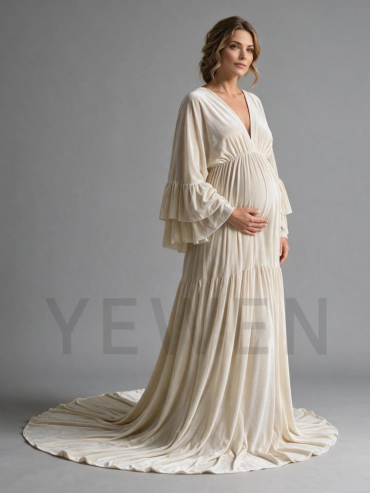 Side profile of a cream velvet maternity photoshoot dress showing the flowing silhouette.