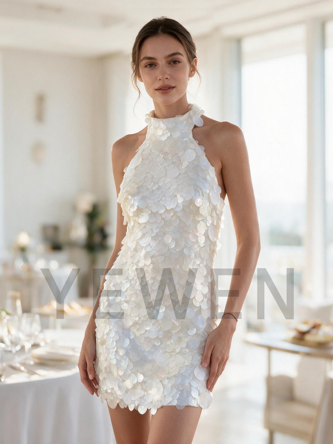 Model wearing a glamorous white sequin evening dress for a party.