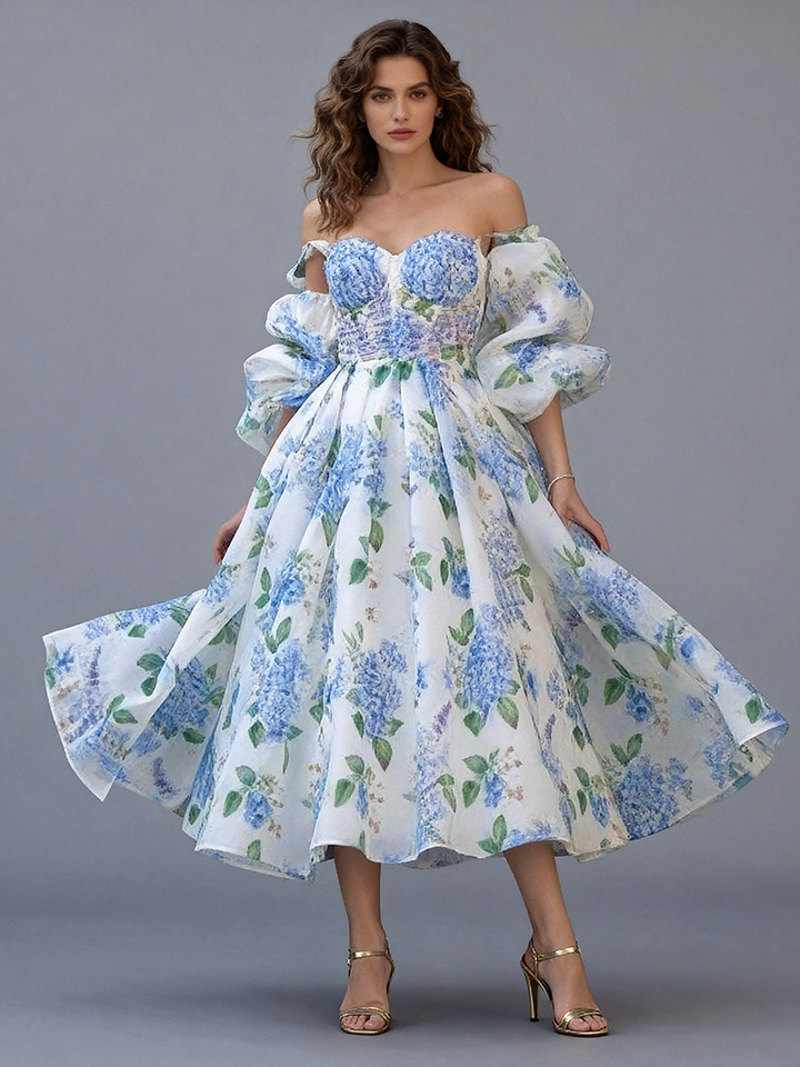 Full front view of a model wearing a blue floral off-shoulder midi party dress with puff sleeves and a pleated A-line skirt.