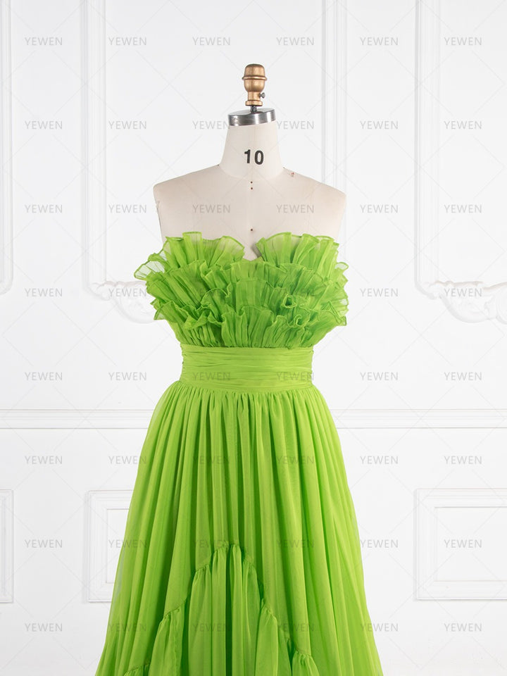 Close-up front view of a lime green ruffle evening gown highlighting the strapless sweetheart neckline and layered ruffle details on a mannequin.