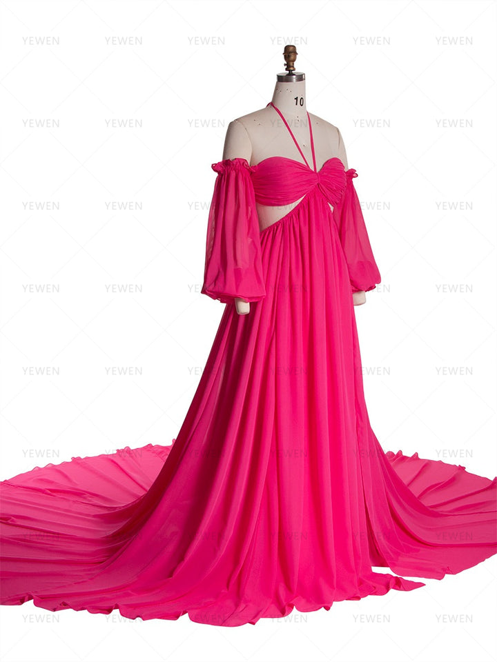 Side view of a hot pink chiffon boho photoshoot dress with a halter neckline detachable puff sleeves a twisted waist and a side slit displayed on a mannequin.