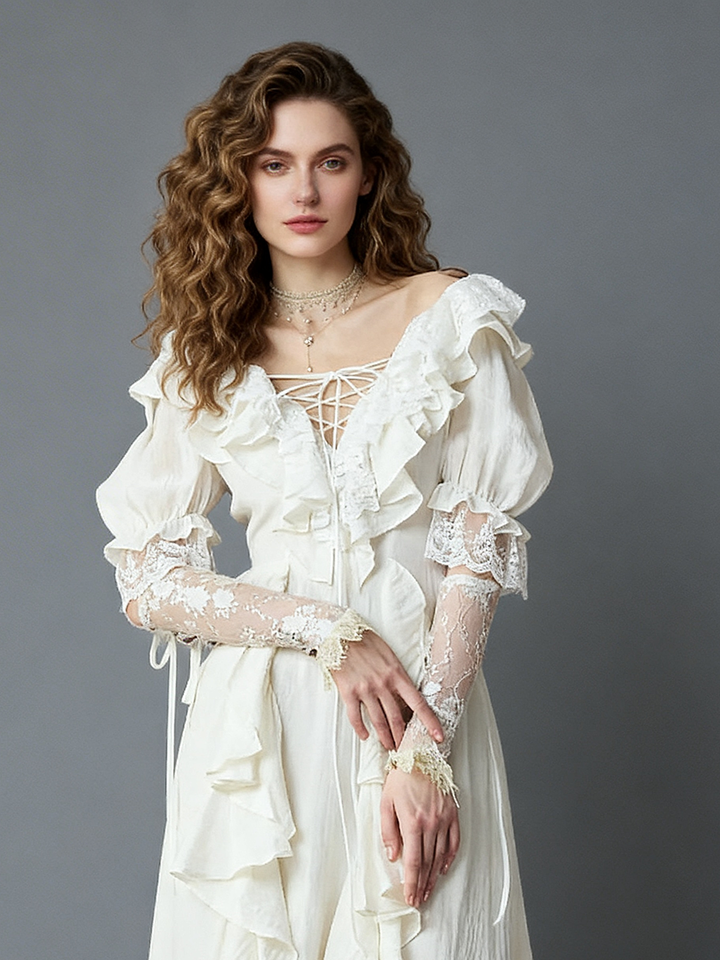Close-up front view of a model wearing an ivory boho ruffle dress highlighting the criss-cross tie V-neckline and lace sleeve details.