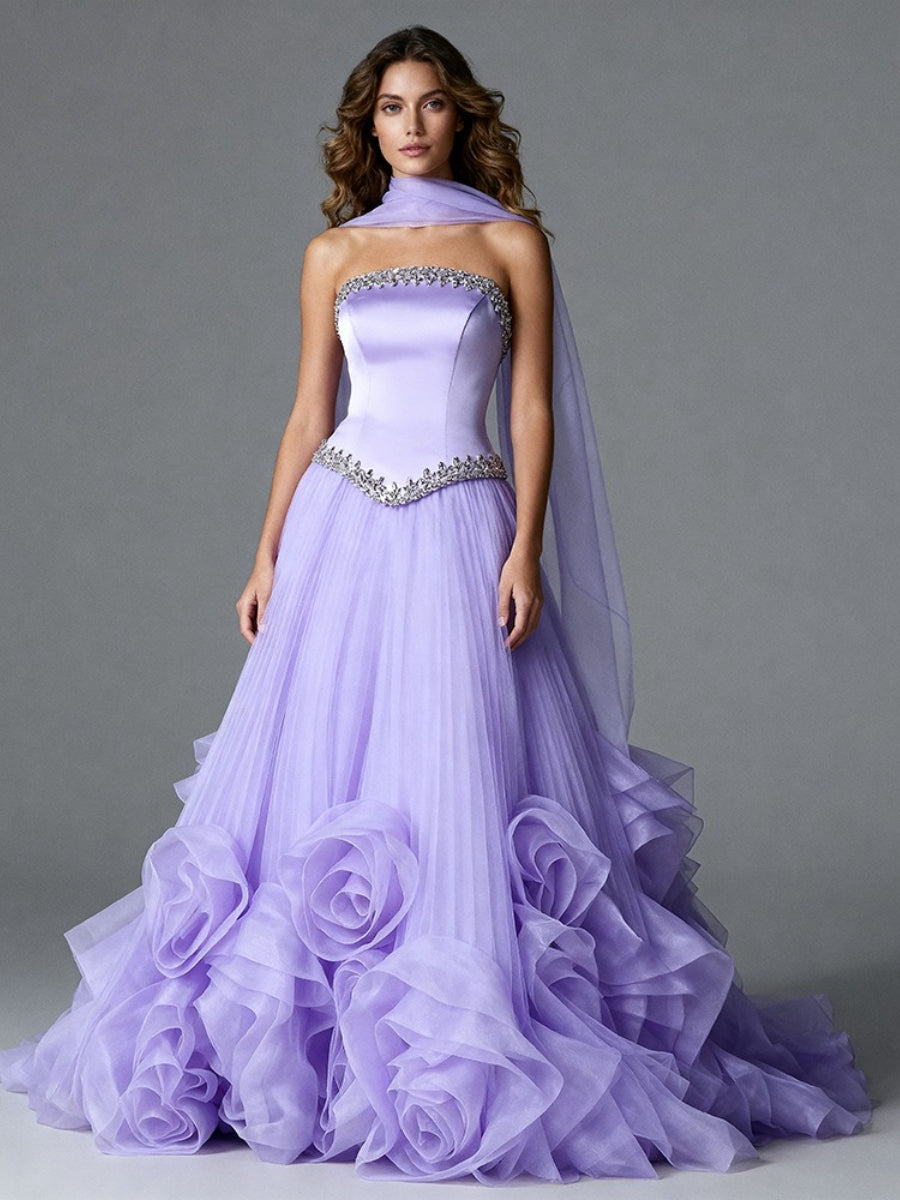 Full front view of a model wearing a lavender strapless evening gown with a long cape and 3D oversized floral details on the skirt.