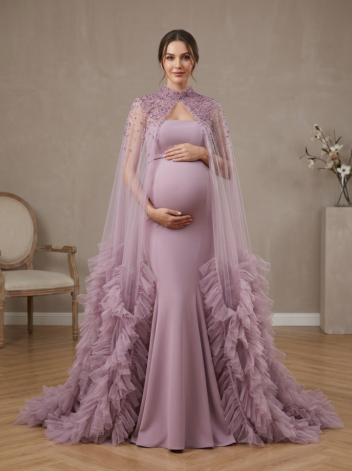 Dusty pink maternity baby shower dress featuring a tulle rose cape and elegant mermaid pregnancy gown design