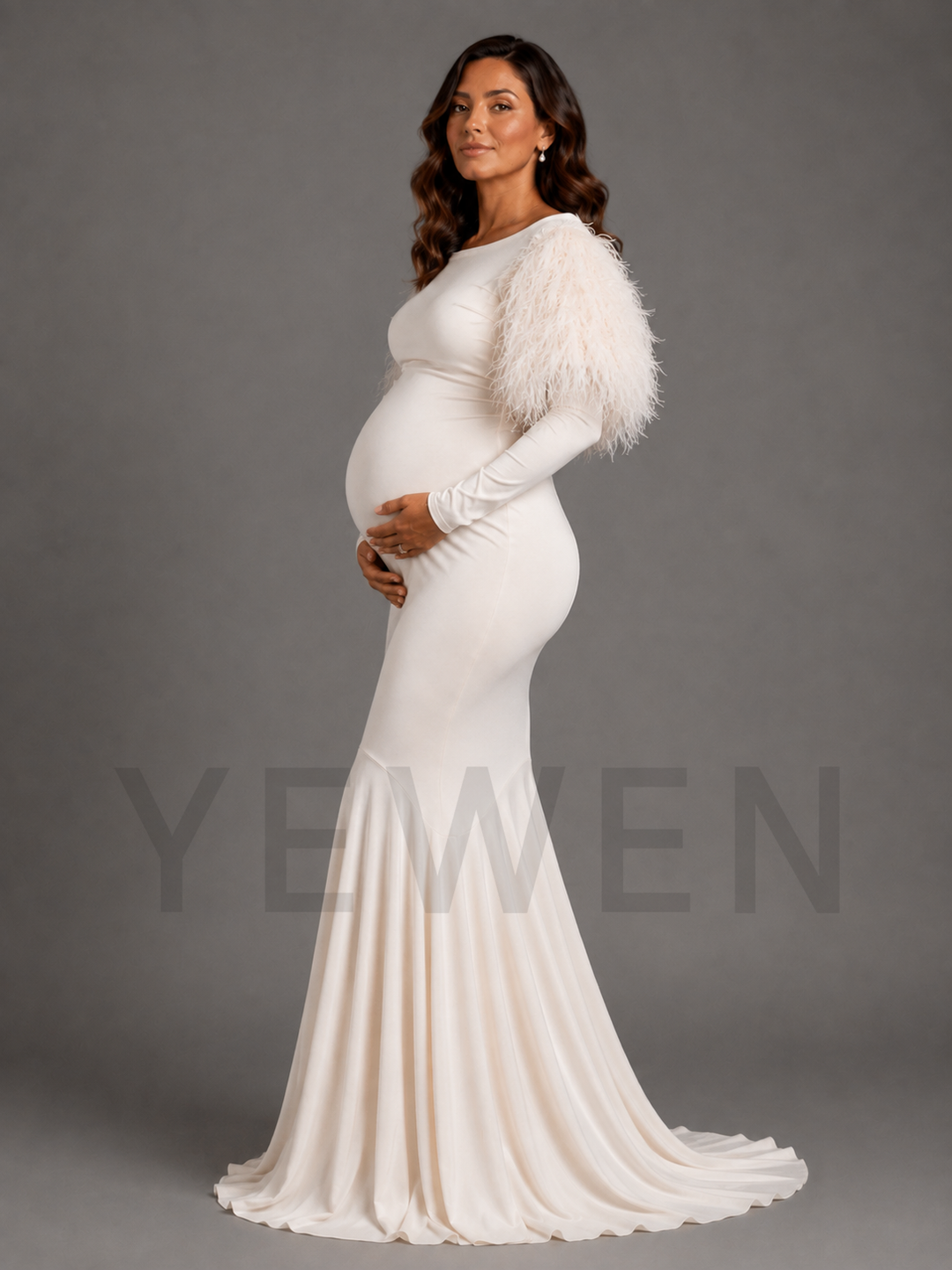 A pregnant woman wearing a fitted ivory maternity gown with a fluffy feathered shoulder cape, standing against a solid gray studio background. A large semi-transparent watermark reading 'YEWEN' is visible across the lower half of the image.