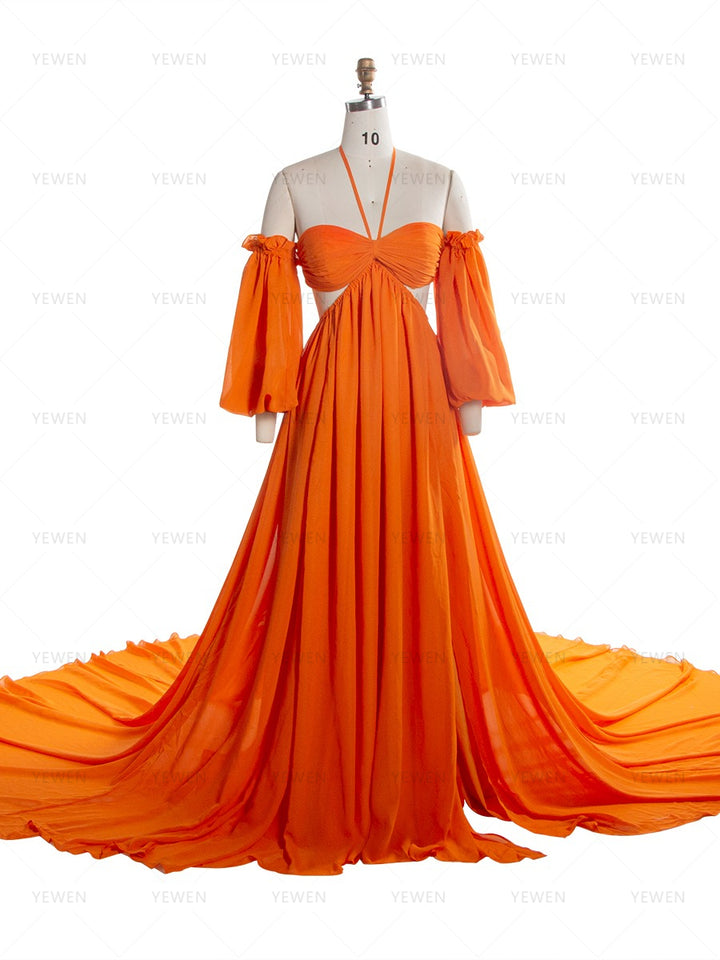 Front view of an orange chiffon boho photoshoot dress with a halter neckline detachable puff sleeves a twisted waist and a side slit displayed on a mannequin.