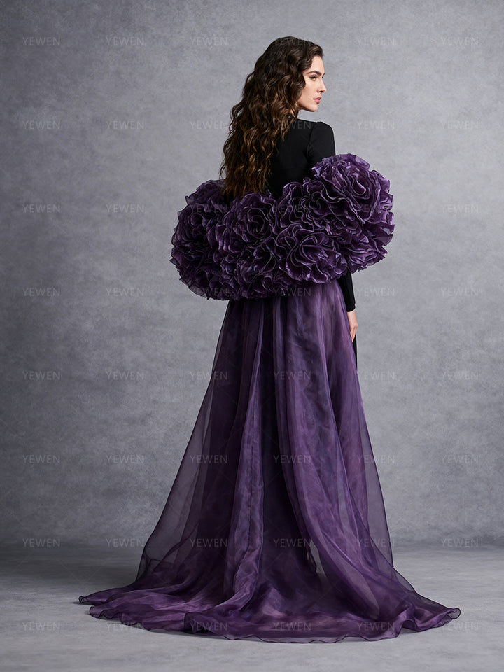 Back profile view of a model wearing a purple detachable bridal cape accessory with oversized handmade flowers and a flowing organza train.