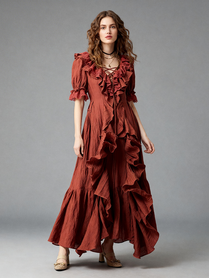 Full front view of a model wearing a rust boho ruffle maxi dress with a V-neckline and layered tiers.