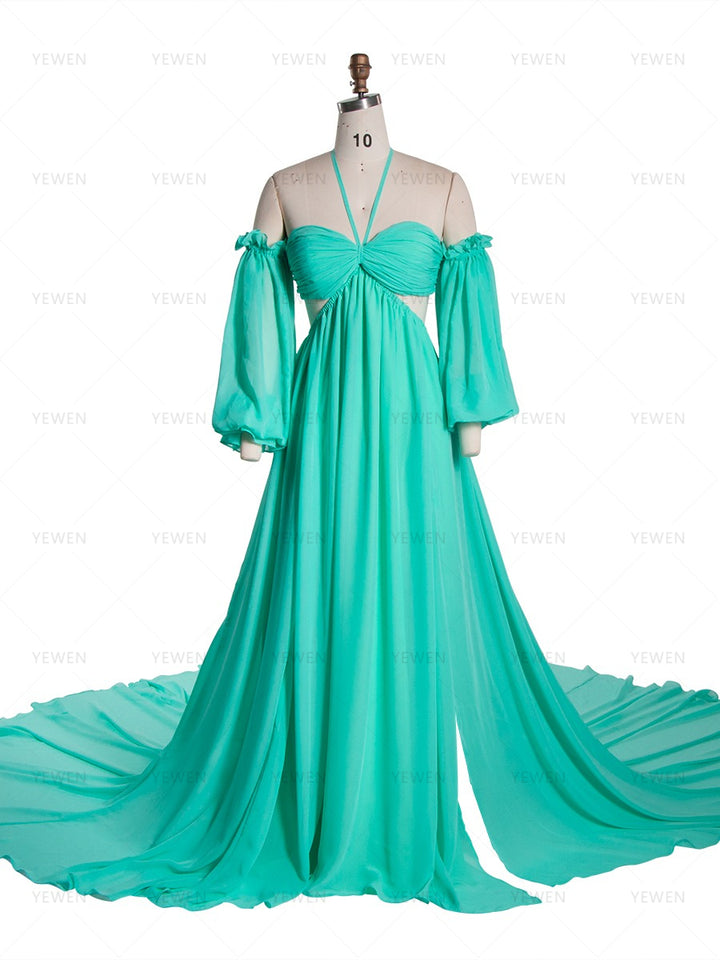 Front view of a teal chiffon boho photoshoot dress with a halter neckline detachable puff sleeves a twisted waist and a side slit displayed on a mannequin.