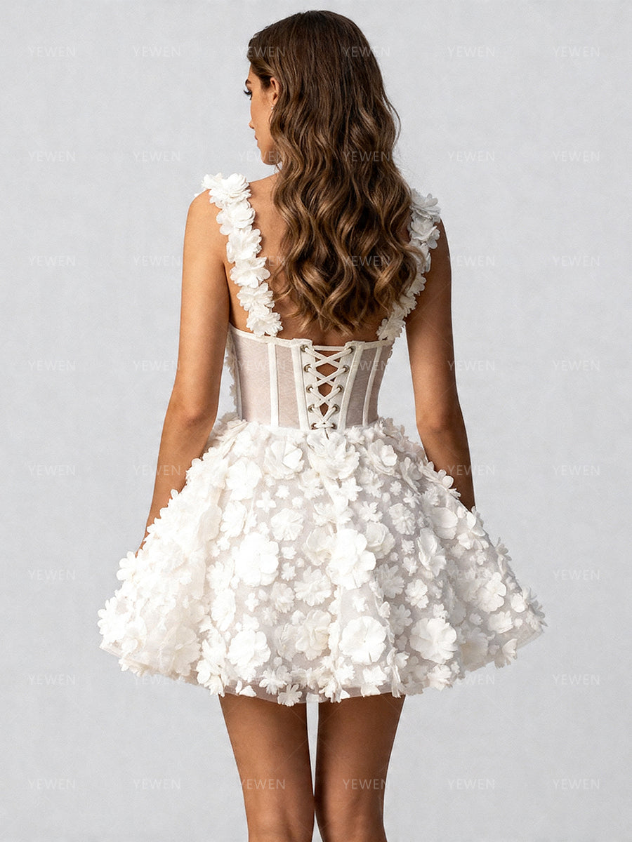 Back view of a model wearing a white 3D floral corset mini prom dress with a lace-up corset back and spaghetti straps.