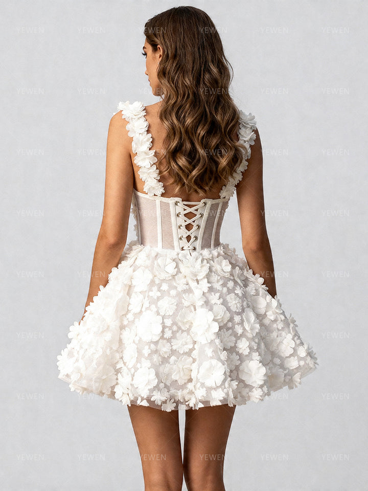 Back view of a model wearing a white 3D floral corset mini prom dress with a lace-up corset back and spaghetti straps.