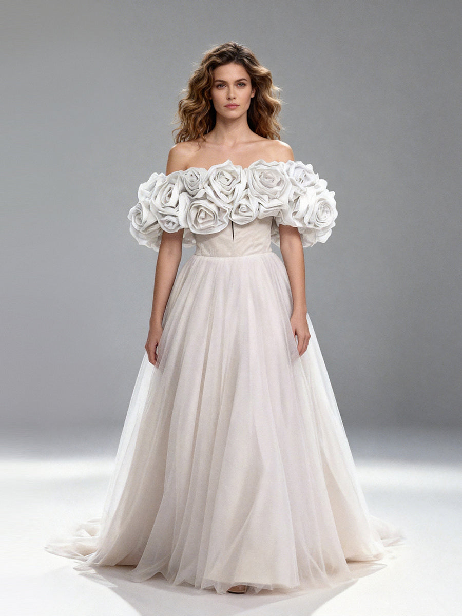 Full front view of a model wearing a white off-shoulder tulle gown with 3D floral details and a flowing A-line skirt.