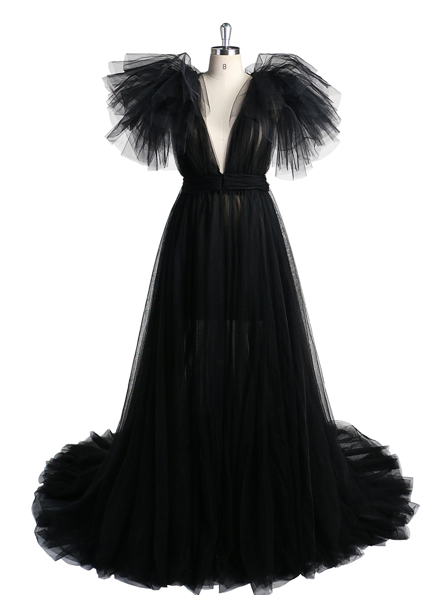 Front view of black maternity dress for photo shoot featuring tulle flowers and elegant flowing maxi design