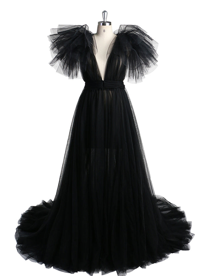 Front view of black maternity dress for photo shoot featuring tulle flowers and elegant flowing maxi design