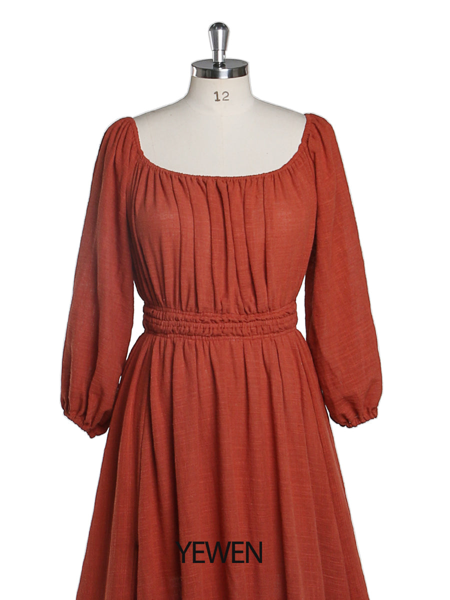 Close-up of rust round neck and full sleeves detail on boho maternity photoshoot dress showing soft elegant fabric