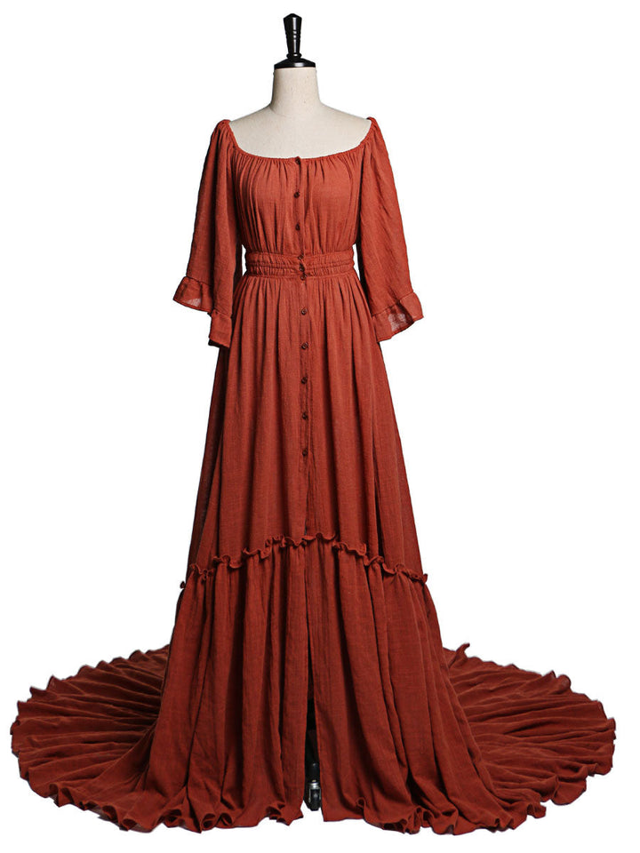 Back view of boho rust photoshoot dress with flare sleeves designed for elegant maternity photography