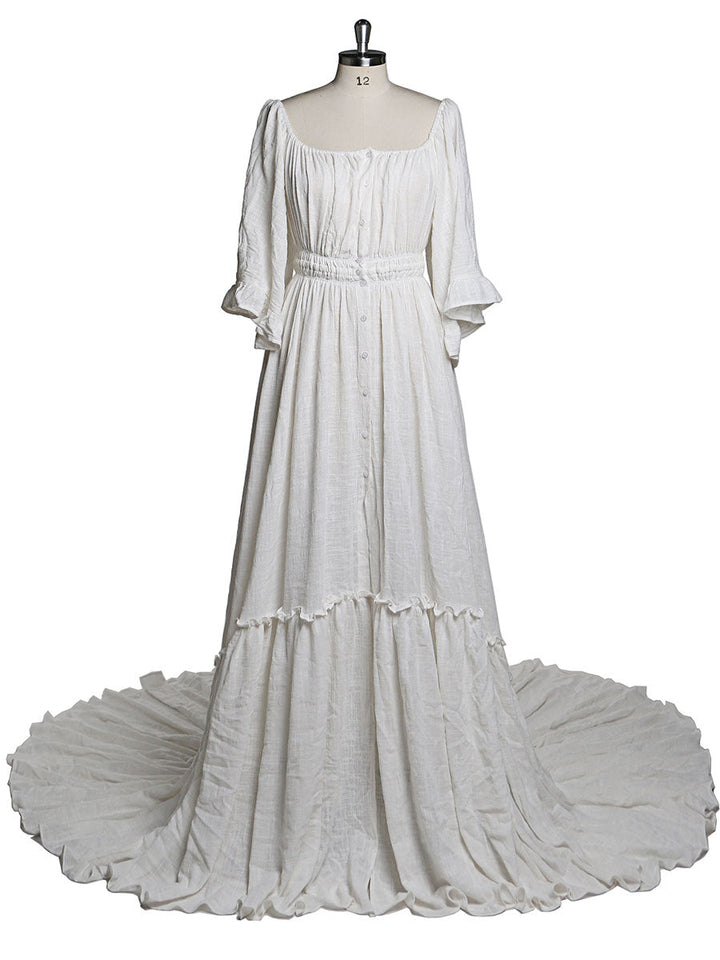 Back view of boho white photoshoot dress with flare sleeves designed for elegant maternity photography