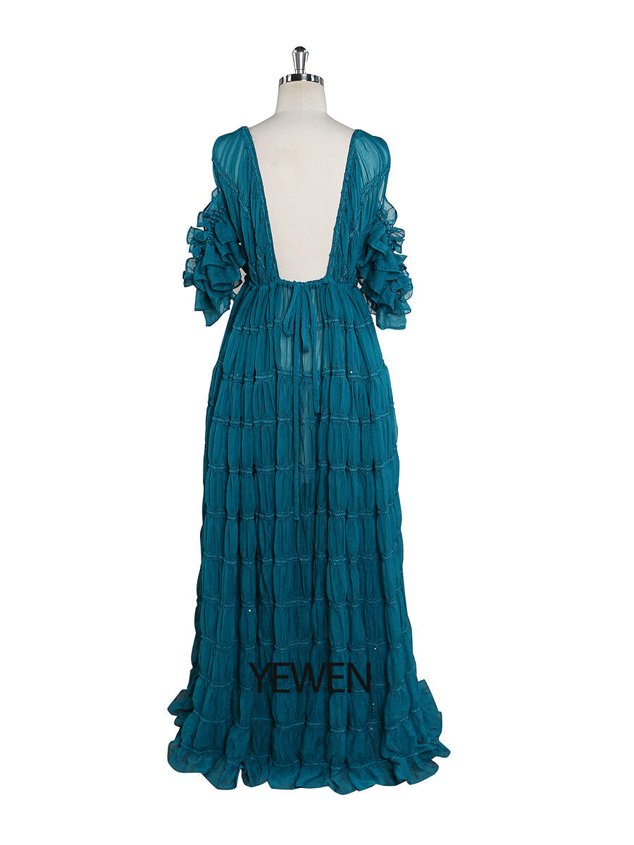 Back view of blue chiffon dress for photo shoot with adjustable shoulder and elegant flowing design