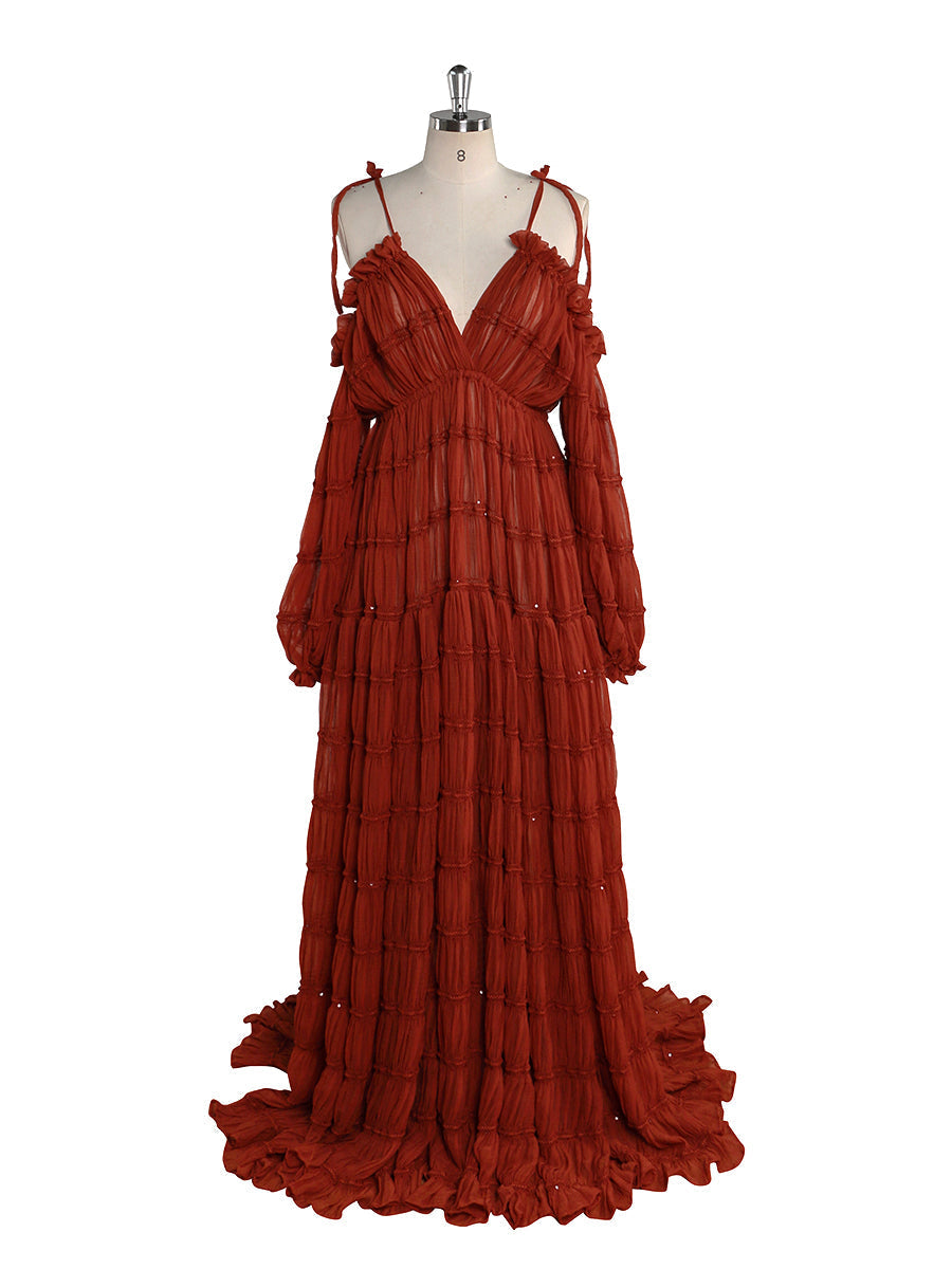 Front view of rust chiffon maternity photoshoot dress featuring off shoulder design and flowing maxi silhouette for elegant photography