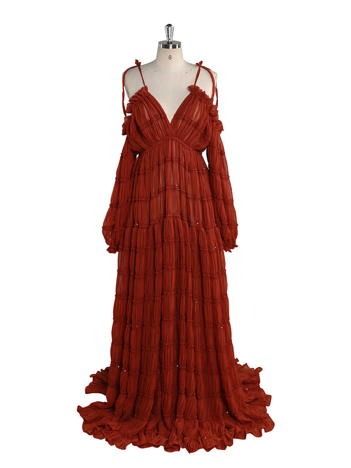 Front view of rust chiffon maternity photoshoot dress featuring off shoulder design and flowing maxi silhouette for elegant photography