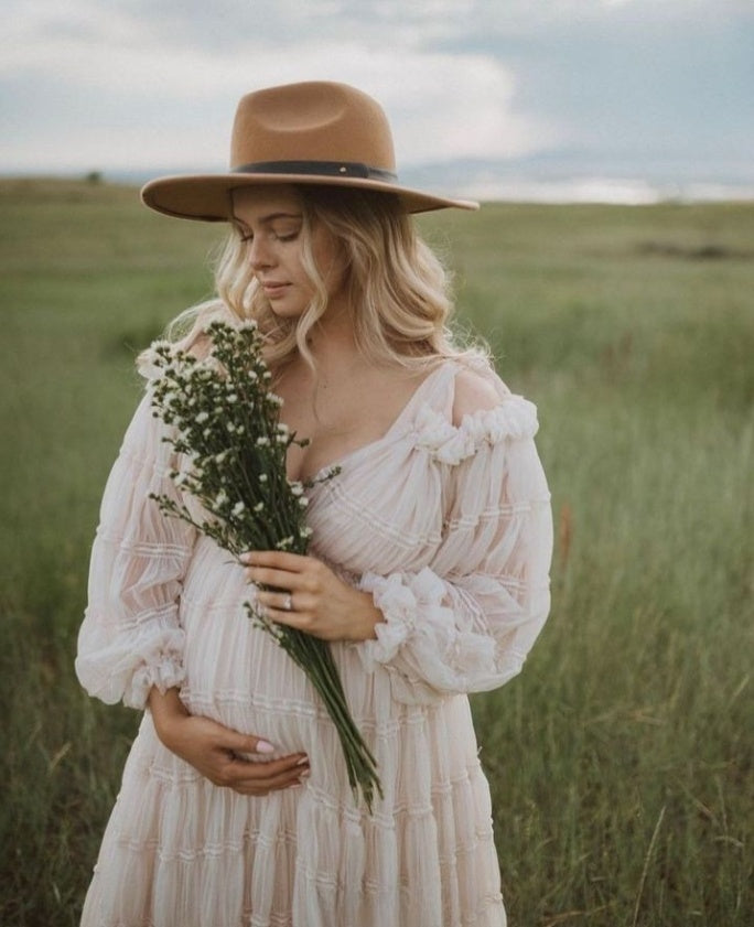 Elegant white chiffon maternity photoshoot dress styled in soft light for romantic pregnancy photography