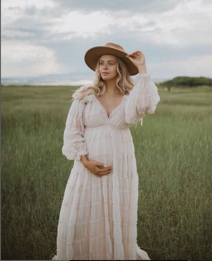 Elegant white chiffon maternity photoshoot dress styled in soft light for romantic pregnancy photography