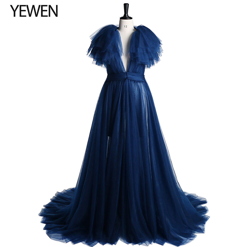 Front view of dark blue maternity dress for photo shoot featuring tulle flowers and elegant flowing maxi design