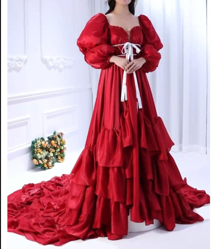 Woman wearing fairy dress during Christmas photo shoot with an elegant red holiday gown