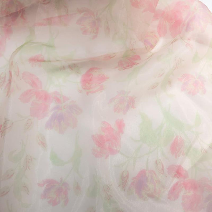 Custom color pink of romantic floral maternity photoshoot dress styled for editorial pregnancy photography with soft organza flowers