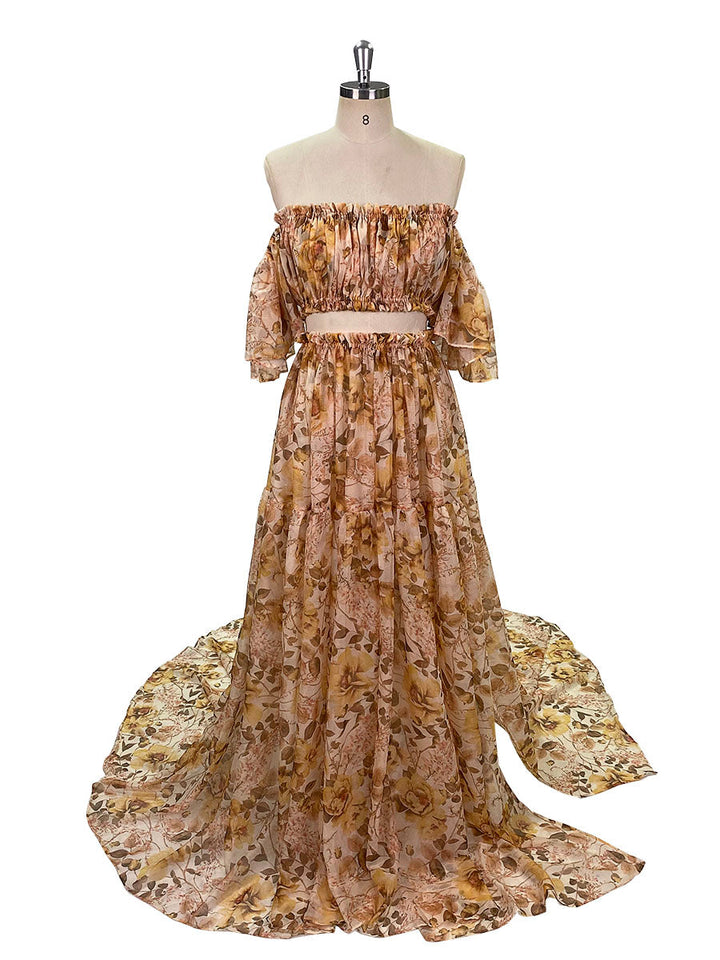 A chiffon print maxi dress with an off-shoulder neckline, side slits, and a floral pattern, displayed on a mannequin.