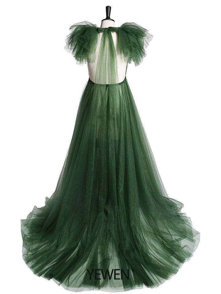 Back view of green maternity dress for photo shoot with elegant tulle flowers and long flowing silhouette