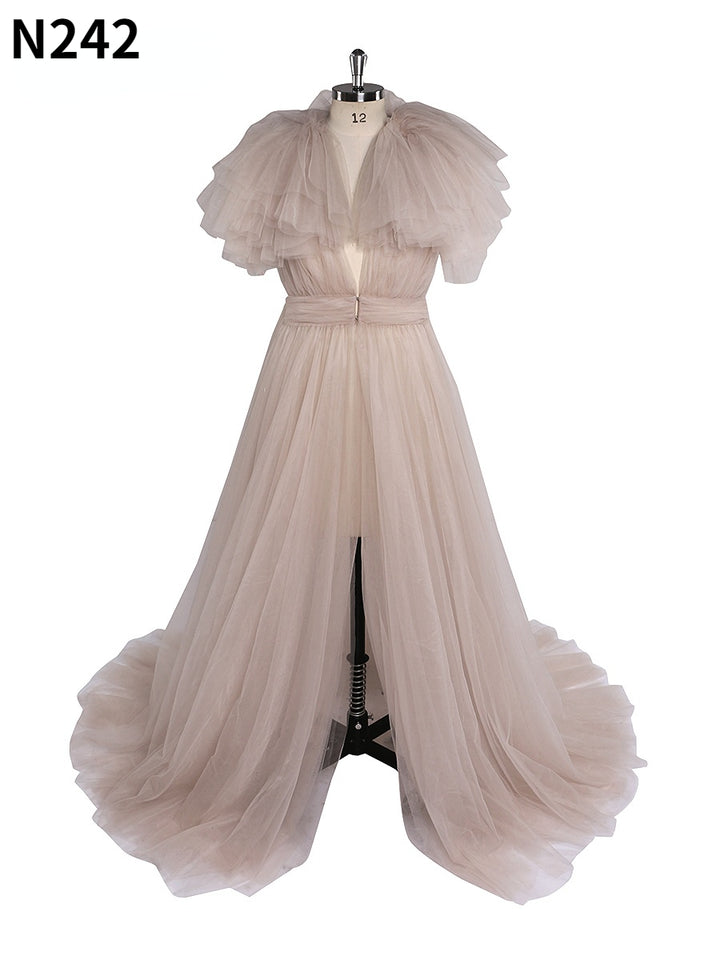 Front view of light pink maternity dress for photo shoot featuring tulle flowers