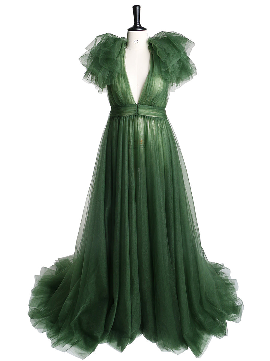 A long green tulle maternity dress with a V-neck, long sleeves, and an open front, designed for photo shoots and baby shower events.